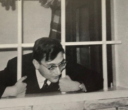 View from outside: Dr. Walter Kemp sticks his head through the bars of a window.